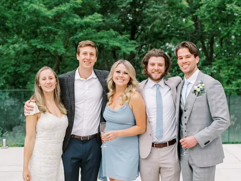 Eric celebrating with friends at an outdoor wedding