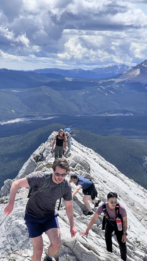 Eric hiking with friends along a rocky mountain ridge
